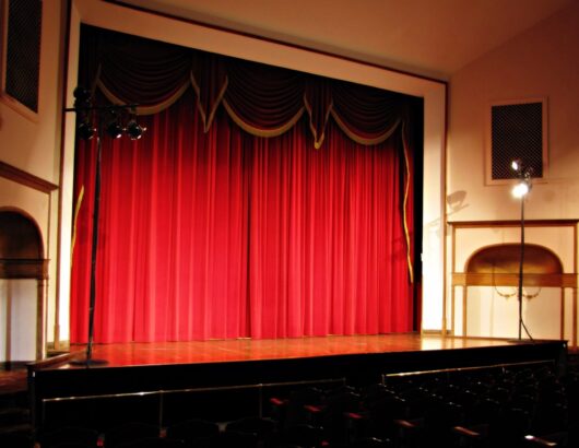 A stage at Ariel Opera House with red curtains