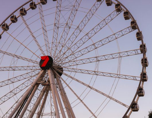 Photo by Josh Withers from Pexels: https://www.pexels.com/photo/a-ferris-wheel-with-a-red-and-white-wheel-28210370/